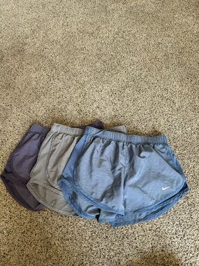 Nike women's running shorts set in blue, gray, and purple